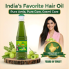Smiling woman holding amla next to a bottle of COSMI Amla Hair Oil, featuring an 'India's No. 1 Hair Oil' trust seal.