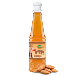 COSMI Almond Hair Oil bottle featuring a 'Badam Tel' Hindi label, placed next to raw almonds.