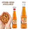 COSMI Almond Hair Oil - Available in 450ml & 600ml Value Sizes Two bottles of COSMI Almond Hair Oil in 450ml and 600ml sizes, displayed next to hands holding fresh almonds.